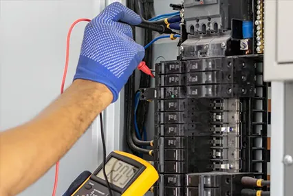 Electrician troubleshooting an electrical panel